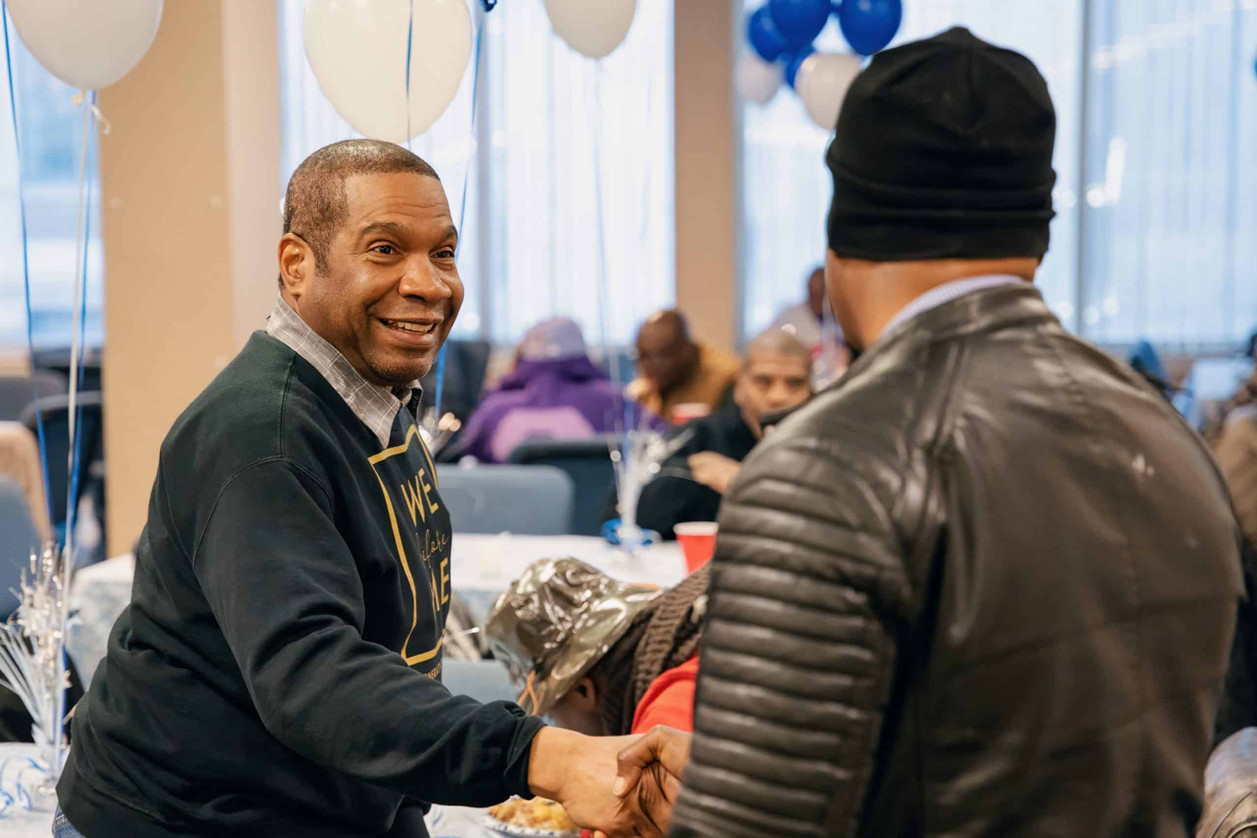 Two men greeting each other at a GMen event