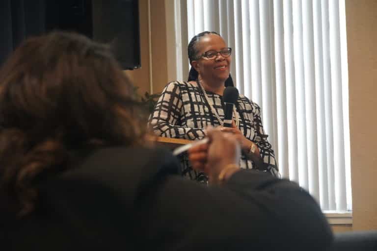 Pastor Sherrie speaking to a group of volunteers